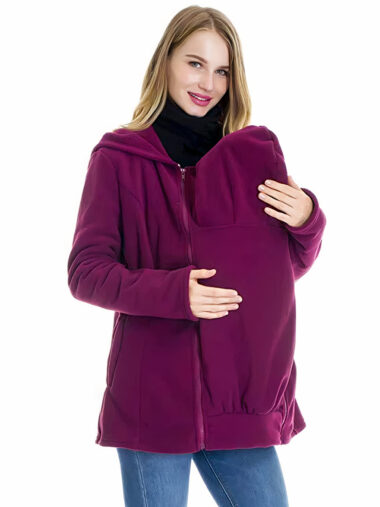 Veste de portage femme conception douce à capuche violette, porté par une femme avec un bébé dans les bras, sur un fond blanc.